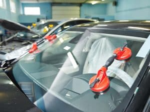 Mazda windscreen replacement in Australia. A professional technician replaces a cracked windscreen on a Mazda car.