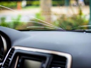 Interior view of a windshield with long cracks, showing types of cracks in windshield needing repair.