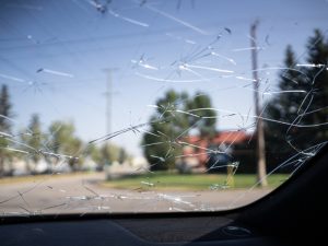 A shattered windscreen, highlighting the importance of a good windscreen cover to protect your vehicle from damage.