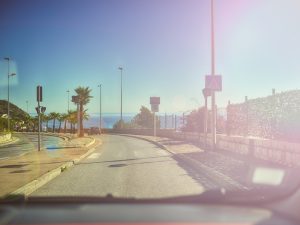 A sunny road ahead, protected from the sun's glare by a best windscreen cover.