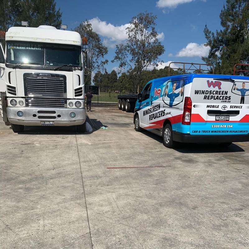 Windscreen Replacers van parked beside large truck during mobile truck windscreen replacement service in Sydney.